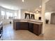 Inviting kitchen featuring dark cabinets, tile flooring, and an open layout at 1248 W Deoni Trl, San Tan Valley, AZ 85143