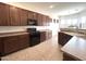 Stylish kitchen with sleek appliances, ample counter space, and dark cabinetry at 1248 W Deoni Trl, San Tan Valley, AZ 85143