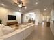 Open-concept living room with tile floors, neutral colors, ceiling fan, and an adjoining dining room at 1248 W Deoni Trl, San Tan Valley, AZ 85143
