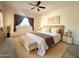 Relaxing main bedroom with ceiling fan, neutral tones, and natural light from the large window at 1248 W Deoni Trl, San Tan Valley, AZ 85143