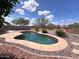 Inviting backyard pool surrounded by desert landscaping, perfect for outdoor relaxation and enjoyment at 1248 W Deoni Trl, San Tan Valley, AZ 85143