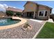 Backyard pool featuring decorative stone landscaping, a pristine pool, and covered patio at 1248 W Deoni Trl, San Tan Valley, AZ 85143