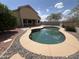 Gorgeous kidney-shaped pool in backyard with desert landscaping and views of the home at 1248 W Deoni Trl, San Tan Valley, AZ 85143