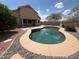 Backyard pool with stone landscaping, a pristine pool, and a desert sky overhead at 1248 W Deoni Trl, San Tan Valley, AZ 85143