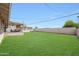 Large backyard featuring a spacious lawn with mature trees and a covered patio at 12627 N 25Th Ave, Phoenix, AZ 85029