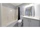 Bright bathroom features a shower-tub combination and a sleek white vanity at 12627 N 25Th Ave, Phoenix, AZ 85029