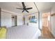 Bright bedroom features fan, white dresser with television, and closet at 12627 N 25Th Ave, Phoenix, AZ 85029
