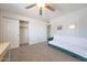 Neutral toned bedroom featuring a ceiling fan, plush carpeting, and closet at 12627 N 25Th Ave, Phoenix, AZ 85029