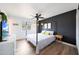 Modern bedroom with hardwood floors, ceiling fan and ensuite at 12627 N 25Th Ave, Phoenix, AZ 85029