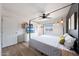 Light bedroom featuring a four-poster bed, fan, and access to an ensuite bathroom and closet at 12627 N 25Th Ave, Phoenix, AZ 85029