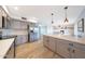 Modern kitchen features stainless steel appliances, subway tile backsplash, and an open layout to the living area at 12627 N 25Th Ave, Phoenix, AZ 85029