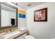 Bathroom featuring granite countertop, framed mirror, and white walls at 1310 E Helena Dr, Phoenix, AZ 85022