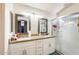 Double vanity bathroom with two mirrors and glass shower at 1310 E Helena Dr, Phoenix, AZ 85022