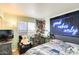 This bedroom features a workspace, neon wall decor, and a comfortable bed in a naturally lit setting at 1310 E Helena Dr, Phoenix, AZ 85022