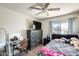 Bedroom with a large dresser, vanity, and window with a view of neighborhood homes and landscaping at 1310 E Helena Dr, Phoenix, AZ 85022