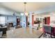 Open-concept dining area with decorative chandelier that connects living room and a modern kitchen at 1310 E Helena Dr, Phoenix, AZ 85022