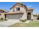 Inviting two-story home with a tile roof, desert landscaping, and a spacious two-car garage at 1310 E Helena Dr, Phoenix, AZ 85022