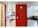 Hallway view to the kitchen and living room with a bright red wall separating the spaces at 1310 E Helena Dr, Phoenix, AZ 85022