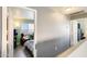 Upstairs hallway with a view into a cozy bedroom featuring a teddy bear and comfortable armchair at 1310 E Helena Dr, Phoenix, AZ 85022