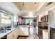 Modern kitchen featuring white cabinets, stainless steel appliances, granite counters, and a stylish backsplash at 1310 E Helena Dr, Phoenix, AZ 85022