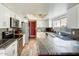 Bright kitchen with granite countertops, stainless steel appliances, white cabinetry, and a tiled backsplash at 1310 E Helena Dr, Phoenix, AZ 85022