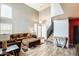 Open concept living room with high ceilings, wood floors, and comfortable seating with an ottoman at 1310 E Helena Dr, Phoenix, AZ 85022