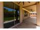 Rear covered patio with ceiling fans, sliding glass door and backyard views at 13213 W Jacobson Dr, Litchfield Park, AZ 85340