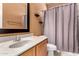 Bathroom featuring a shower, mirror, vanity with storage, and shelves, optimizing functionality and convenience at 13213 W Jacobson Dr, Litchfield Park, AZ 85340