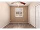 Bedroom featuring wood-look floors, a closet, and a window with white shutters, blending style and functionality at 13213 W Jacobson Dr, Litchfield Park, AZ 85340