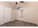 Bedroom featuring a ceiling fan and closet with wood-look floors and neutral walls, creating an inviting space at 13213 W Jacobson Dr, Litchfield Park, AZ 85340