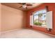 Bedroom featuring a ceiling fan and a window with white shutters, inviting natural light and fresh air at 13213 W Jacobson Dr, Litchfield Park, AZ 85340