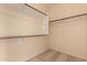 An empty walk-in closet offers plenty of storage space with installed shelving and rods for organization at 13213 W Jacobson Dr, Litchfield Park, AZ 85340