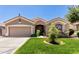 Charming home featuring a well-manicured lawn, desert landscaping and neutral color palette at 13213 W Jacobson Dr, Litchfield Park, AZ 85340