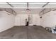 Spacious garage featuring storage cabinets, water softener, and ample room for vehicles and storage at 13213 W Jacobson Dr, Litchfield Park, AZ 85340