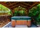 Covered hot tub featuring wood beam construction and stone accents at 13213 W Jacobson Dr, Litchfield Park, AZ 85340