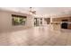 Spacious living room with tile floors, ceiling fan and backyard access at 13213 W Jacobson Dr, Litchfield Park, AZ 85340