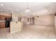 A spacious living room with neutral tile flooring, recessed lighting, and a ceiling fan offers a comfortable and inviting atmosphere at 13213 W Jacobson Dr, Litchfield Park, AZ 85340