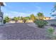 Expansive backyard with gravel, mature landscaping, and a built-in barbecue area at 13304 W Palo Verde Dr, Litchfield Park, AZ 85340