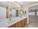 Bathroom featuring a double sink vanity with a large mirror and updated fixtures at 13304 W Palo Verde Dr, Litchfield Park, AZ 85340