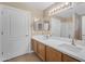 Bathroom featuring a double sink vanity, neutral walls, and stylish decor at 13304 W Palo Verde Dr, Litchfield Park, AZ 85340