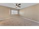 Bedroom showcasing neutral walls, carpet, ceiling fan, and window providing a cozy retreat at 13304 W Palo Verde Dr, Litchfield Park, AZ 85340