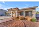 Attractive home featuring a three-car garage, well-manicured landscaping and a welcoming front porch at 13304 W Palo Verde Dr, Litchfield Park, AZ 85340