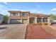 Inviting two-story home with a three-car garage, red brick walkway, and well-maintained landscaping at 13304 W Palo Verde Dr, Litchfield Park, AZ 85340