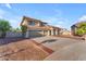 Desirable home with a spacious three-car garage, a tile roof, and attractive landscaping at 13304 W Palo Verde Dr, Litchfield Park, AZ 85340
