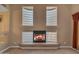 Living room fireplace with glass block windows and a carpeted floor at 13304 W Palo Verde Dr, Litchfield Park, AZ 85340
