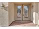 Close-up of elegant double front doors with decorative glass and a brick walkway leading up to the entrance at 13304 W Palo Verde Dr, Litchfield Park, AZ 85340