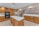 Spacious kitchen with granite countertops, stainless steel appliances, and an eat-in kitchen island at 13304 W Palo Verde Dr, Litchfield Park, AZ 85340