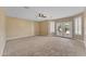 Spacious living room with a ceiling fan and french doors leading to the backyard at 13304 W Palo Verde Dr, Litchfield Park, AZ 85340