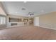 Large living room with carpet flooring and a ceiling fan at 13304 W Palo Verde Dr, Litchfield Park, AZ 85340