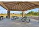 Shaded picnic area with tables and grill in a grassy park setting for outdoor enjoyment at 13304 W Palo Verde Dr, Litchfield Park, AZ 85340